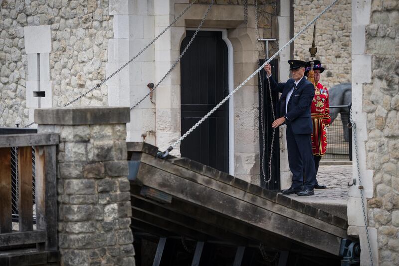 A guard lowers the Middle Drawbridge during a ceremonial event to mark the reopening to the public of the Tower of London. Getty Images