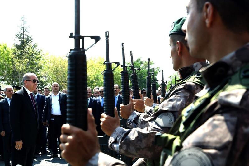 Turkish president Recep Tayyip Erdogan, left, reviews special police forces' at their headquarters in Ankara on July 29, 2016. Kayhan Ozer Presidential Press Service, via AP, Pool