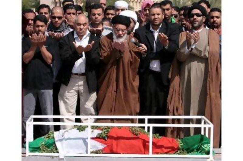 Mourners pray at the funeral of Fadel Salman Matrouk in Manama yesterday. Mr Matrook was killed on Tuesday as police tried to stop a funeral march for another Bahraini who was killed in anti-government protests on Monday.