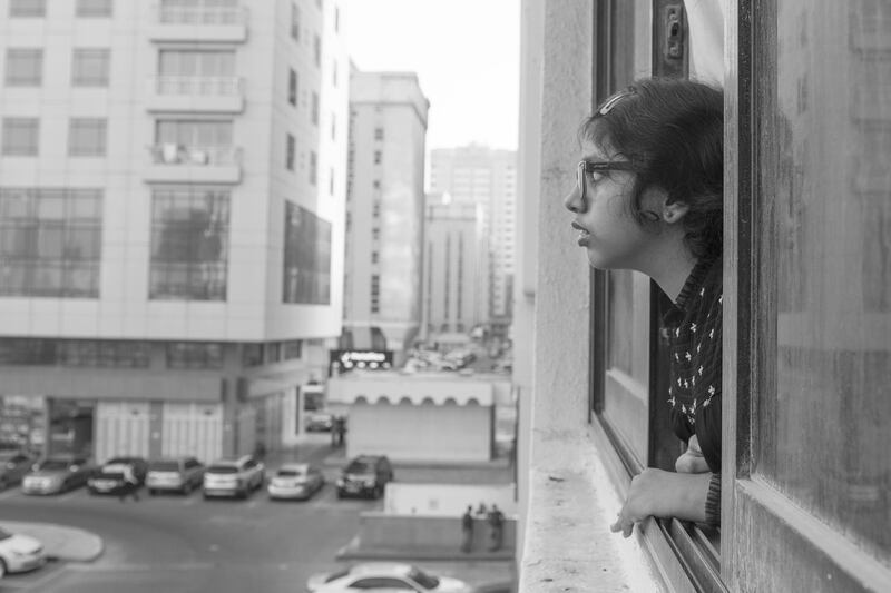 Vidhyaa Chandramohan's daughter looks outside the window of their Abu Dhabi flat. Vidhyaa Chandramohan