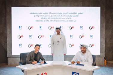 Peng Xiao, chief executive of G42, left, and Omar Al Suwaidi, an Adnoc executive, right, during the signing ceremony with Dr Sultan Al Jaber. Courtesy Adnoc