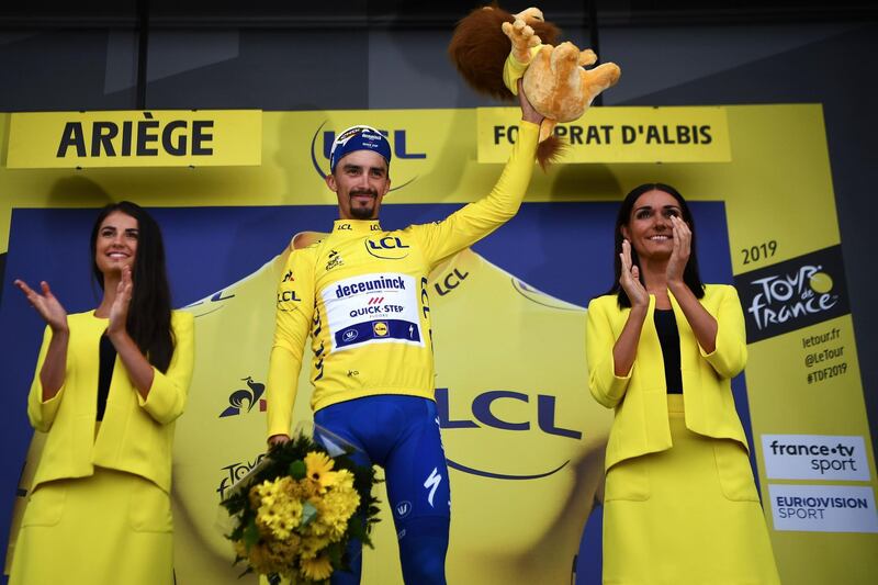 France's Julian Alaphilippe celebrates on the podium after the 15th stage between Limoux and Foix Prat d'Albis, on July 21, 2019.  AFP