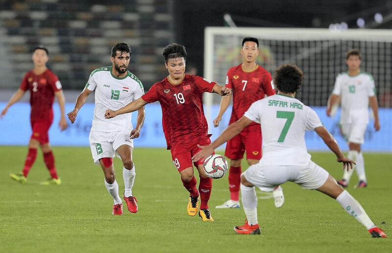 ABU DHABI , UNITED ARAB EMIRATES , January 8 – 2019 :- Nguyen Quang Hai ( no 19 in red ) of Vietnam in action during the AFC Asian Cup UAE 2019 football match between IRAQ vs. VIETNAM held at Zayed Sports City in Abu Dhabi. Iraq won the match by 3-2. ( Pawan Singh / The National ) For News/Sports