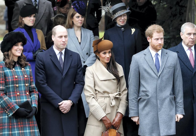 Britain's Catherine, Duchess of Cambridge, (L) and Britain's Prince William, Duke of Cambridge, (2L), US actress and fiancee of Britain's Prince Harry Meghan Markle (2R) and Britain's Prince Harry (R) stand together as they wait to see off Britain's Queen Elizabeth II after attending the Royal Family's traditional Christmas Day church service at St Mary Magdalene Church in Sandringham, Norfolk, eastern England, on December 25, 2017. (Photo by Adrian DENNIS / AFP)