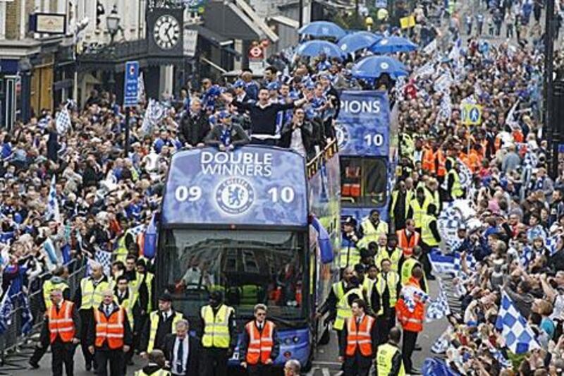 Chelsea players react to fans' cheers during their victory bus parade in London yesterday.