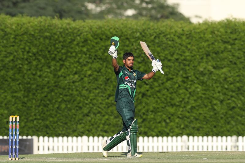 Shahzaib Khan raises his bat after reaching his fifty at the ICC Academy Ground in Dubai