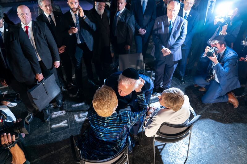 US President Joe Biden speaks to Holocaust survivors Dr Gita Cycowicz and Rena Quint in the Hall of Remembrance, at Yad Vashem in Jerusalem. AP  