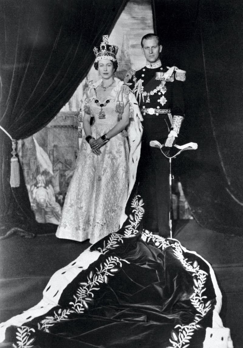 The Queen Elizabeth II and the Prince Philip pose after the Queen's Coronation, 02 June 1953 in Buckingham Palace. (Photo by - / - / AFP)