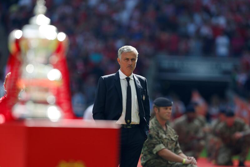 Manchester United's Portuguese manager Jose Mourinho (C) stands by as the team's are introduced for the FA Community Shield football match between Manchester United and Leicester City at Wembley Stadium in London on August 7, 2016.  / AFP PHOTO / Ian Kington / NOT FOR MARKETING OR ADVERTISING USE / RESTRICTED TO EDITORIAL USE