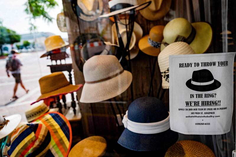 (FILES) In this file photo taken on May 12, 202, a hat store advertises that they are hiring in Annapolis, Maryland.  New filings for weekly unemployment benefits hit a new pandemic low in the US last week, government data showed on May 13, 2021, bolstering the case that Covid-19 vaccines are allowing businesses to rehire. The Labor Department reported 473,000 new seasonally adjusted claims for jobless benefits made in the week ended May 8, fewer than expected and 34,000 less than the previous week's upwardly revised level. / AFP / JIM WATSON
