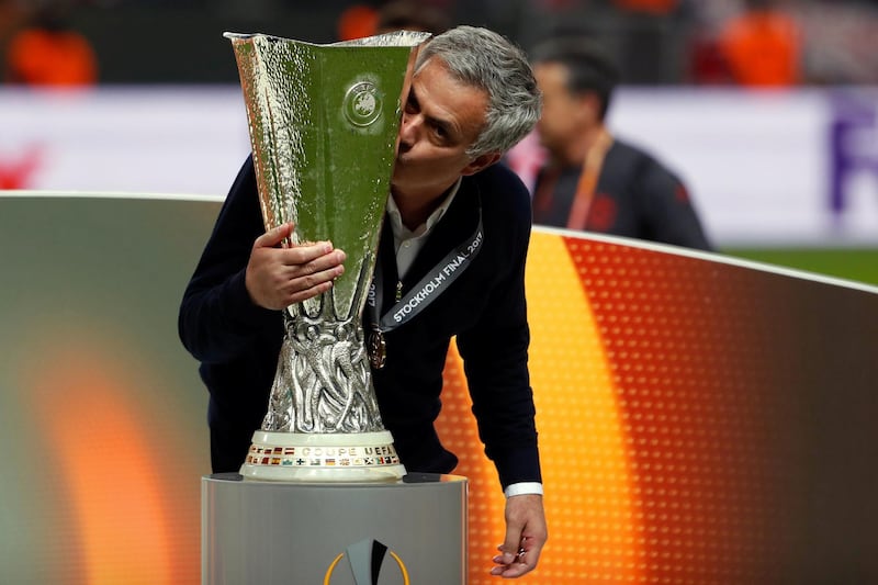 Manchester United's Portuguese manager Jose Mourinho kisses the trophy after the UEFA Europa League final football match Ajax Amsterdam v Manchester United on May 24, 2017 at the Friends Arena in Solna outside Stockholm. / AFP PHOTO / Odd ANDERSEN