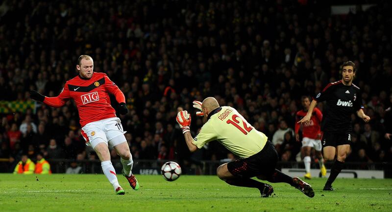MANCHESTER, ENGLAND - MARCH 10: Wayne Rooney of Manchester United scores the 2nd goal during the UEFA Champions League First Knockout Round, second leg match between Manchester United and AC Milan at Old Trafford on March 10, 2010 in Manchester, England. (Photo by Laurence Griffiths/Getty Images)