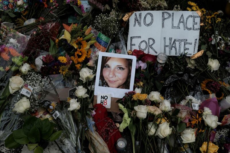 A photograph of Charlottesville victim Heather Heyer is seen amongst flowers left at the scene of the car attack on a group of counter-protesters that took her life during the "Unite the Right" rally in Charlottesville, Virginia, on August 14, 2017. Reuters