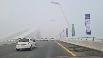 Drivers contend with foggy conditions on Sheikh Khalifa Bridge in Abu Dhabi. The National