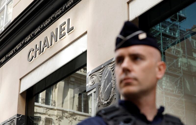 A French police officer stands guard in front of the Chanel shop after a robbery in central Paris. Reuters