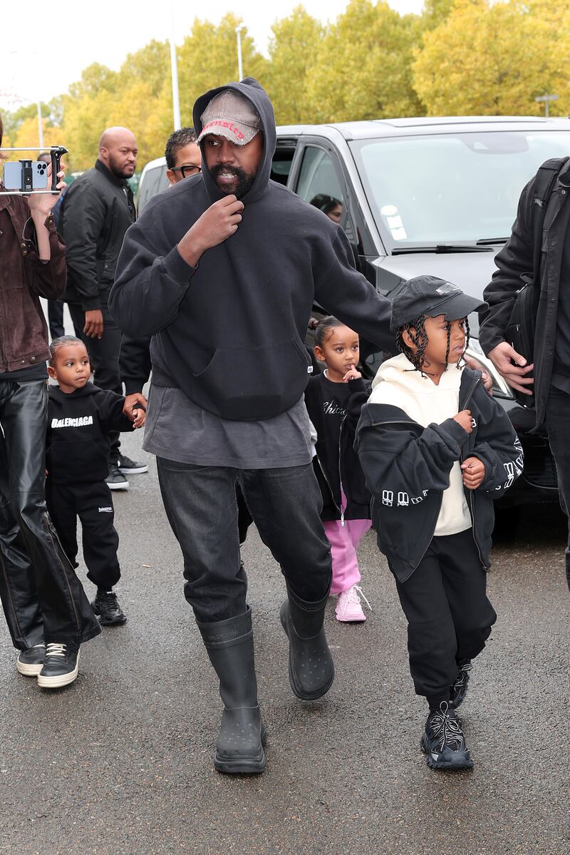 Kanye West arrives at the Balenciaga spring/summer 2023 show, with his children. He went on to make his modelling debut, opening the show. Getty