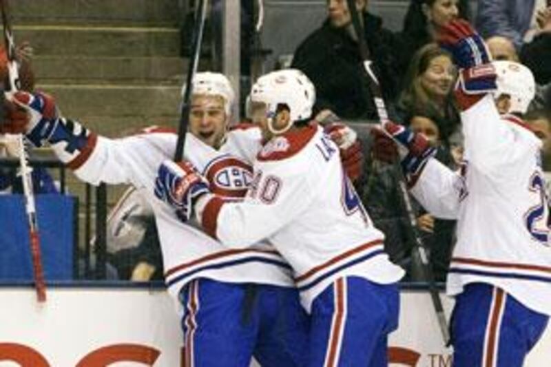 Montreal Canadiens Guillaume Latendresse (left) celebrates his first period goal against the Toronto Maple Leafs with team mates Maxim Lapierre (centre) and Josh Gorges.