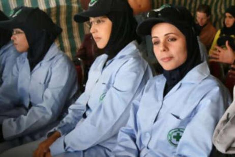 JABER- JORDAN: Sabah Qteish, right, watch with other female graduates during a de-miners graduating ceremony for the first female de-miners in the Middle East, near the Syrian border with Jordan in Jaber, Jordan, November 25, 2008. (Salah Malkawi/ The National) *** Local Caption ***  SM010_DeMining.jpg