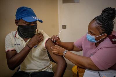 A South African receives a second vaccination against Covid-19 as infection rates soar across the country. But the Omicron variant could prove to be a 'good thing', according to a leading virologist. EPA