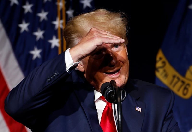 Former U.S. President Donald Trump shields his eyes while speaking about the media at the North Carolina GOP convention dinner in Greenville, North Carolina, U.S. June 5, 2021.  REUTERS/Jonathan Drake