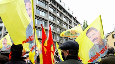 Kurdish protesters carry flags with a portrait of jailed Kurdistan Workers Party (PKK) leader Abdullah Ocalan during a demonstration in front of the U.S. Consular Agency in Zurich, Switzerland April 29, 2021. REUTERS/Arnd Wiegmann