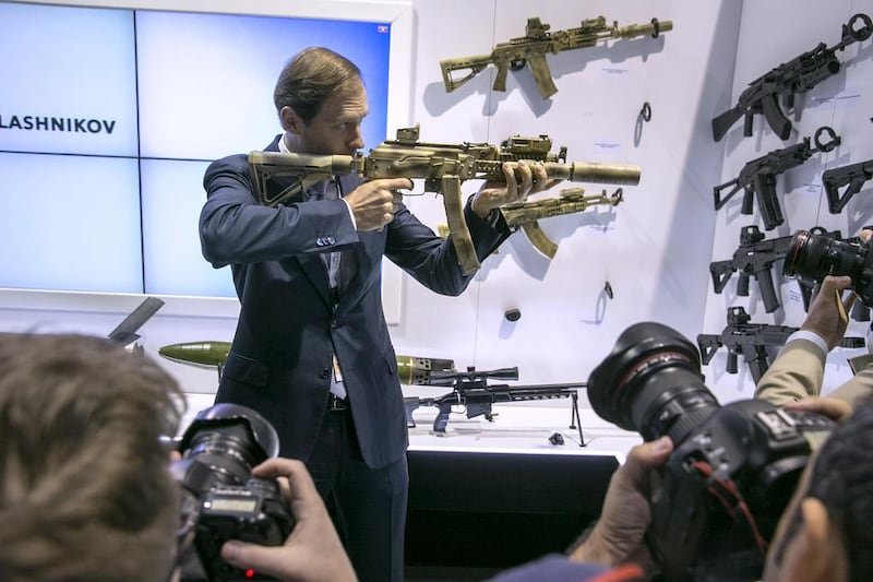 Denis Manturov, the Russian industry and trade minister, checks out one of the assault rifles at the Kalashnikov Group stand at the International Defense Exhibition & Conferences 2015 in Abu Dhabi. Silvia Razgova / The National
