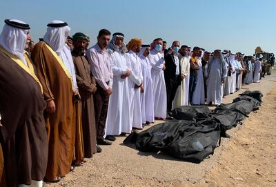 Sunni Muslim men pray over the bodies of eight out of 12 fellow Iraqis, who were reportedly kidnapped on October 17 and later some of them found shot dead, during their burial ceremony in the Farhatiya area of the Balad region, located 70 kilometres (around 45 miles) north of Baghdad in the Salaheddin province, on October 18, 2020.   Local sources said the four other kidnapped men have not been found and the identity of the assailants remains unknown in the mysterious crime. / AFP / -
