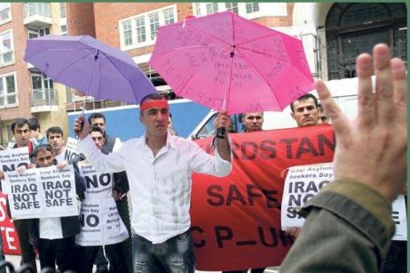 Protestors stand outside the Home Office, London in this 2005 File Photo to protest against the deportation of failed Iraqi asylum seekers 26 August 2005. The Refugee Council and Iraqi community Groups believe it is not safe to send asylum seekers back to Iraq when ongoing insurgency in the country is at a high level . AFP PHOTO/ CARL DE SOUZA, 2005.