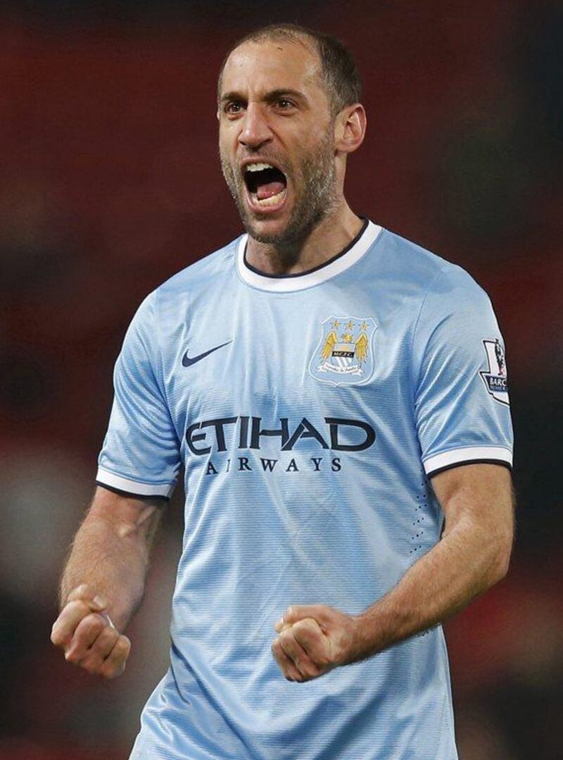 Manchester City defender Pablo Zabaleta reacts after beating Manchester United on Tuesday. Phil Noble / Reuters / March 25, 2014