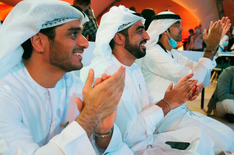 Emirati men claps as they watch the launch of the "Amal" or "Hope" space probe at the Mohammed bin Rashid Space Center in Dubai, United Arab Emirates, Monday, July 20, 2020. A United Arab Emirates spacecraft, the "Amal" or "Hope" probe, blasted off to Mars from Japan early Monday, starting the Arab world's first interplanetary trip. (AP Photo/Jon Gambrell)