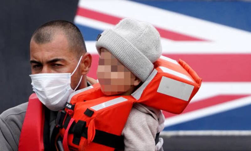 A child is carried  off a UK Border Force vessel, in Dover, Kent, on England's south coast, after a small boat was intercepted in the English Channel. Getty