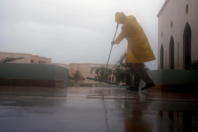 A member of staff removes the rain water covered a corridor at a hotel in Salalah, Oman. Cyclone Mekunu will be "extremely severe" when it crashes into the Arabian Peninsula.  Kamran Jebreili / AP Photo