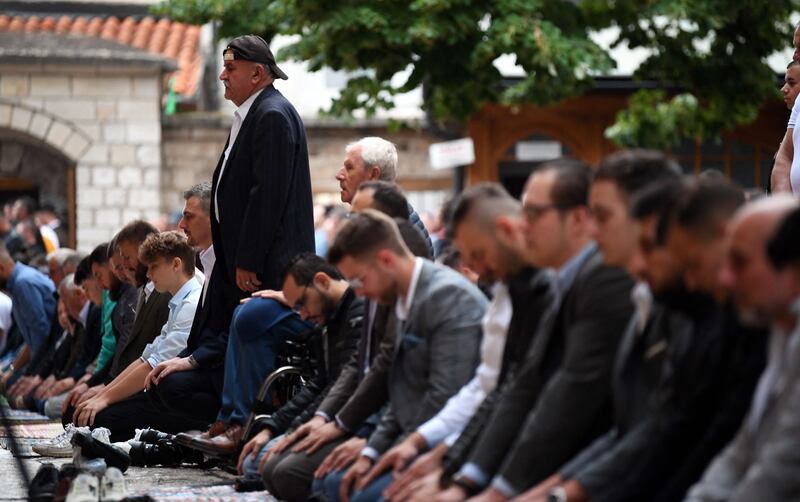 Bosnian Muslims pray during early morning prayer on Eid Al Adha outside Gazi-Husref Bey, central mosque. AFP