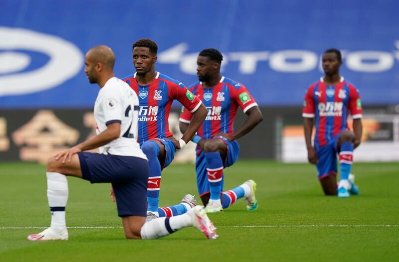 Wilfried Zaha and other players from Crystal Palace and Tottenham Hiotspur take a knee ahead of the Premier League match. Getty Images