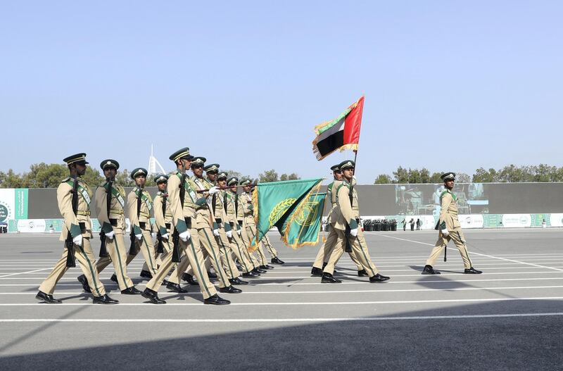 Police officers take part in a military parade during the Dubai Police Academy graduation ceremony on Tuesday. Wam