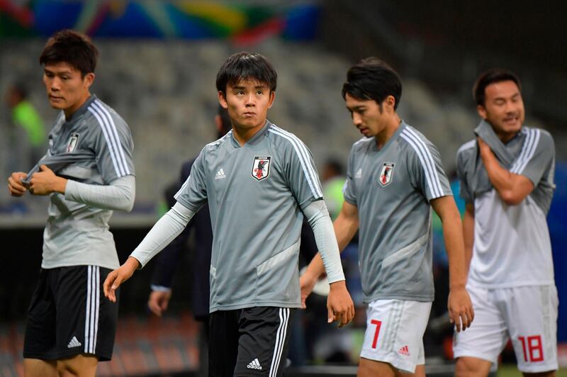 Japan's Takefusa Kubo, dubbed the 'Japanese Messi', warms up with teammates before the match. AFP