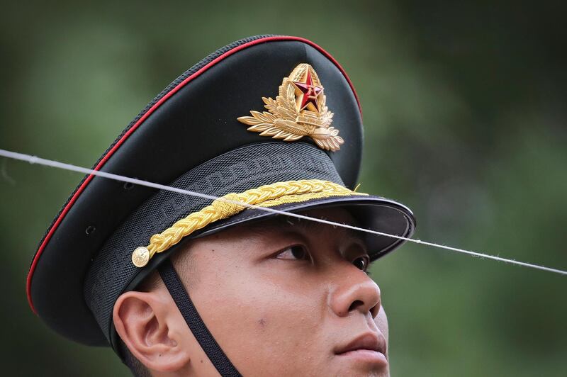 A member of China's honour guard gazes on a string as he and his comrades prepare for a welcome ceremony for visiting Kyrgyzstan President Sooronbay Jeenbekov. Andy Wong / AP Photo