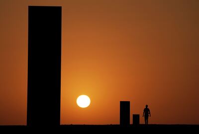 The 'East-West/West-East' sculpture by American artist Richard Serra, at sunset in Qatar's Dukhan desert.  AFP