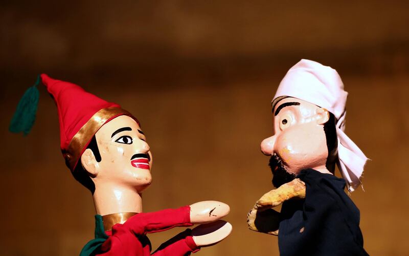 Wooden puppets from Egypt's Aragoz puppets show perform in Beit al-Sehemi, in Cairo's Gamaliya district. AFP