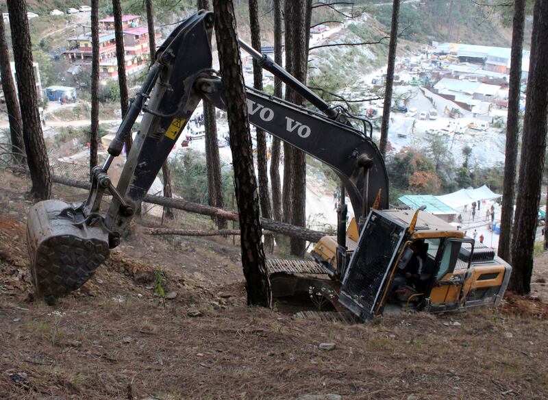 An earthmover at the top of a mountain where a tunnel collapsed in Uttarakhand state, India, on Saturday. AP