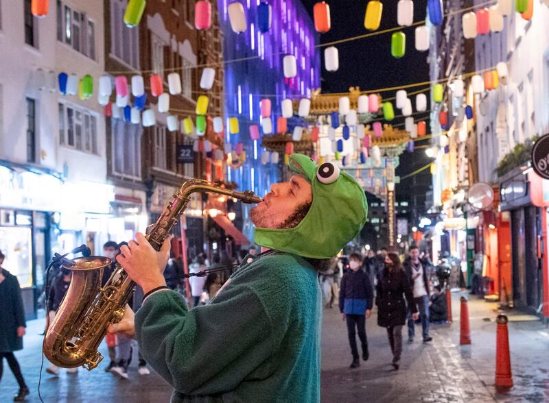 A man plays the saxophone in London. Britain's Health Secretary Hancock announced that London and its surrounding areas will be placed under Tier 3 restrictions. EPA