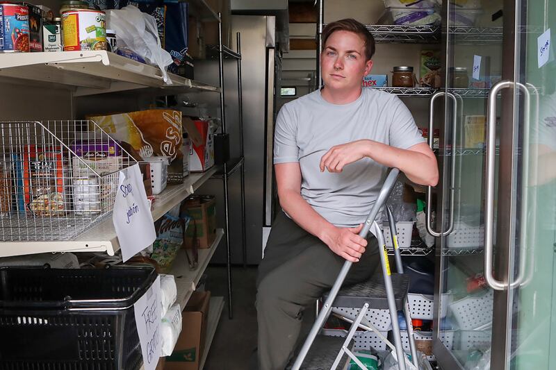 Ash Hermanowski, food access and operations manager of the Jackson Cupboard in Jackson Hole, hands out meals from a garage after the nonprofit's location flooded.  AP