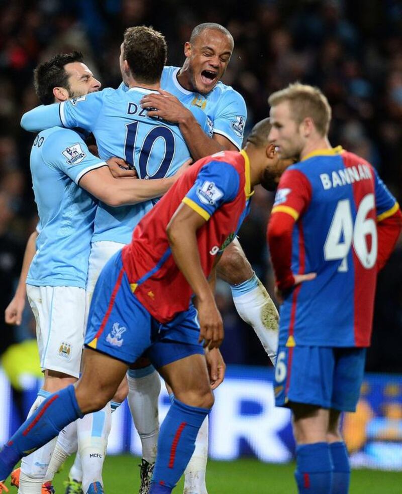 Edin Dzeko, No 10, celebrates with his Manchester City teammates after scoring the only goal in a 1-0 victory over Crystal Palace on Saturday. Andrew Yates / AFP