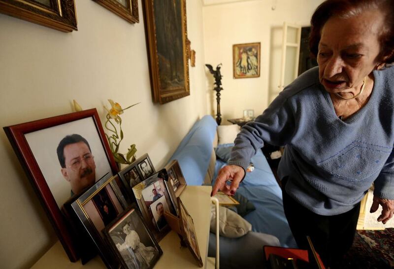 Marie Mansourati, 83, adjusts pictures of her kidnapped son Dani, more than two decades after he was taken by Syrian troops to Damascus, at her house in Beirut on April 8, 2015. Joseph Eid/AFP Photo

