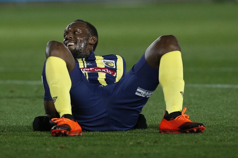 Usain Bolt lies on the pitch after taking a shot at goal during a pre-season friendly for Central Coast Mariners. AP Photo