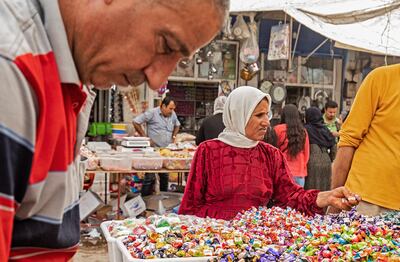 A woman shops for sweets at the main market in Qamishli. AFP