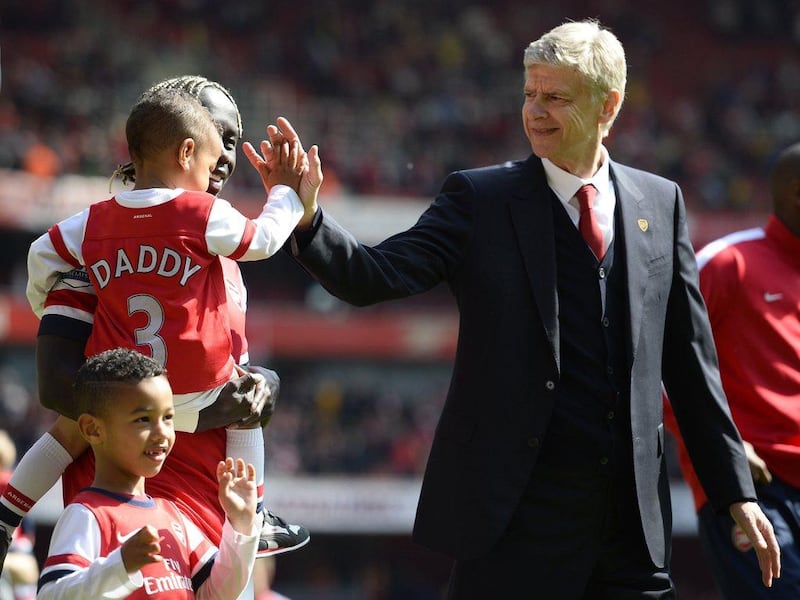 Arsenal manager Arsene Wenger greets Bacary Sagna's children as they walk around the pitch after their win over West Bromwich Albion on Sunday. Dylan Martinez / Reuters / May 4, 2014