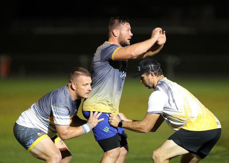 Llewellyn Wessels, left, Ruan Steenkamp, centre, and coach Henry Paul train before a practice match between the Dubai Hurricanes and defending school champs JESS ahead of Emirates Dubai Sevens. All photos Chris Whiteoak / The National
