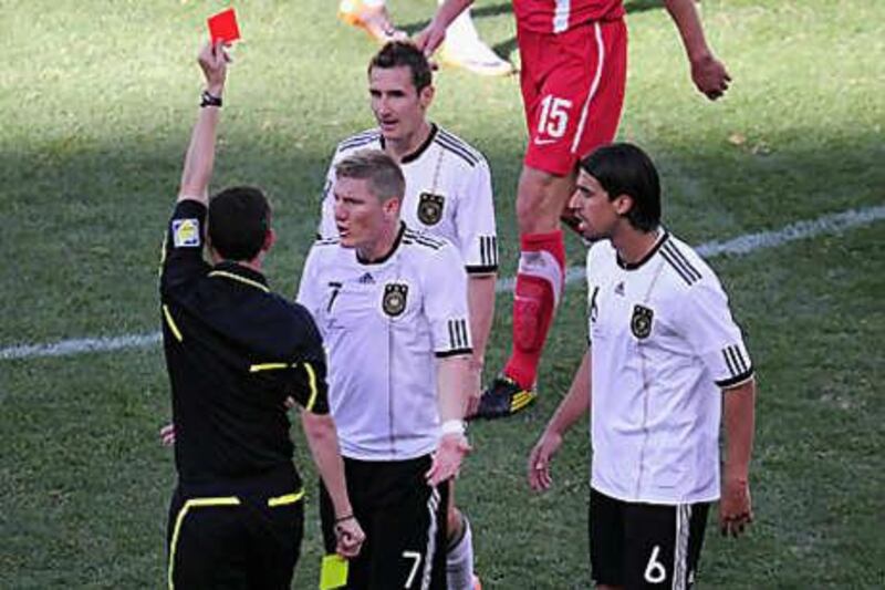 Miroslav Klose, top, was shown a second yellow card and sent off by Alberto Undiano in Port Elizabeth yesterday. Joachim Loew's side were the victims of a startlingly bad refereeing performance.