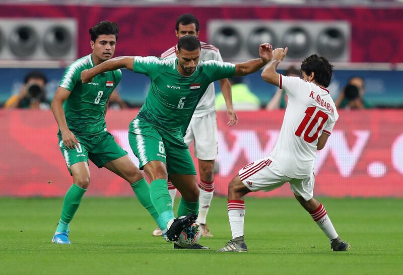 Iraq's Ali Adnan in action against Khalfan Mubarak of UAE. Reuters